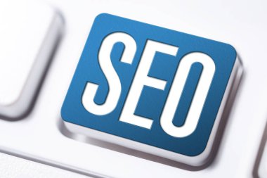 Blue SEO Search Engine Optimization Button On A White Keyboard, Business Marketing Concept