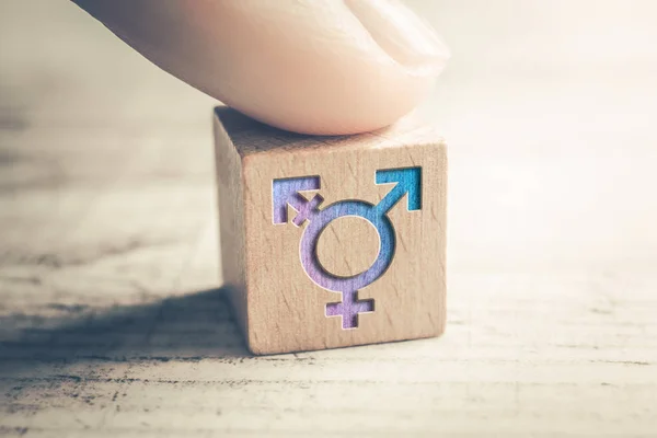 Transgender, LGBT or Intersex Icon On A Wodden Block On A Table Arranged By A Finger — Stock Photo, Image