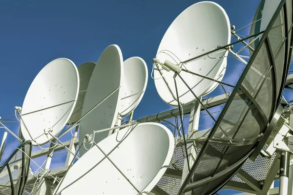 Satellite dish on blue sky background — Stock Photo, Image