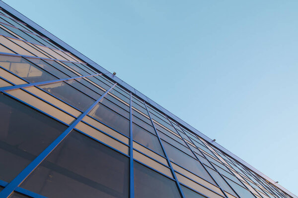 The glass facade on the background of blue sky