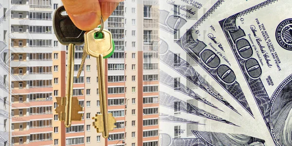 The keys to the apartment on a background of money and houses . — Stock Photo, Image