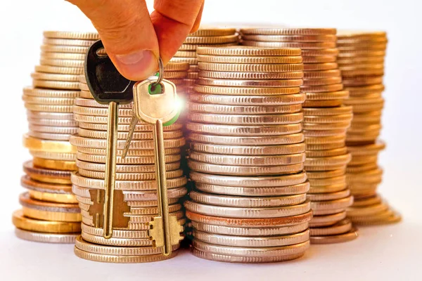 The keys to the apartment on a background of money . Stock Image