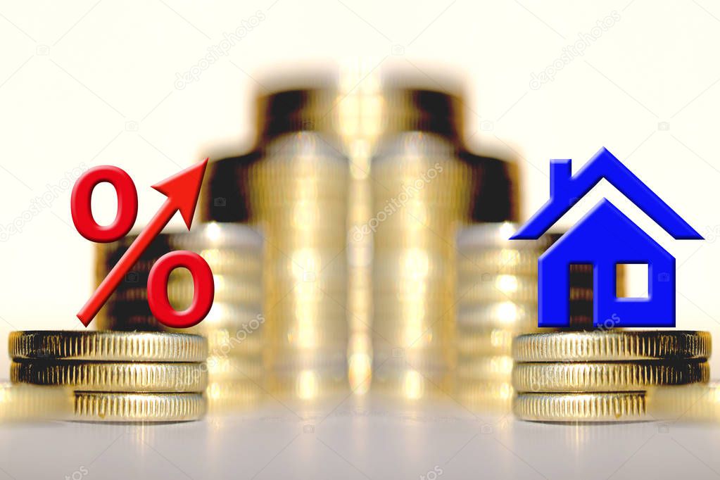 The percent symbol nd real estate and on the background of bars coins .
