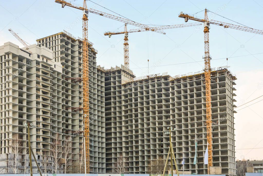 Construction of new residential buildings against the sky  . The concept of the construction business .