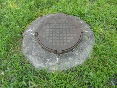 manhole in city summer park