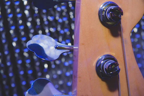 Mavi arka planı olan bir elektro gitarın tepesi..