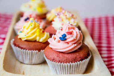 Taze tereyağı kremalı, beyaz ve gül soslu kırmızı kadife kek. Çapa ya da ananas gibi küçük renkli serpintilerle birlikte. Her biri farklı bir odak noktasından. 