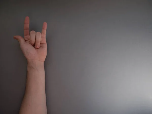 Female Hand Shows Gesture Rock Horns Gray Background Copy Space — Stock Photo, Image