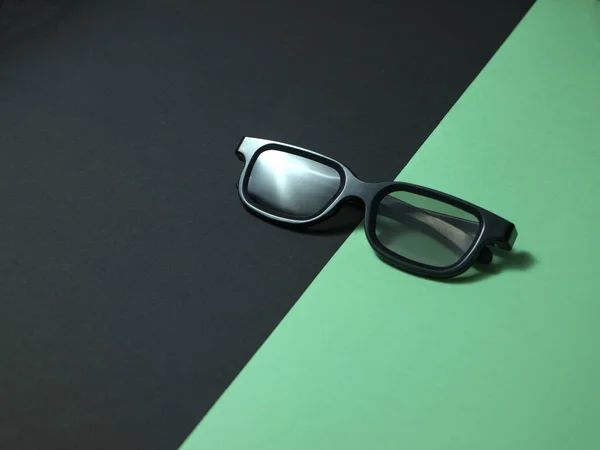 Svart 3D plast glasögon på färgad bakgrund. — Stockfoto