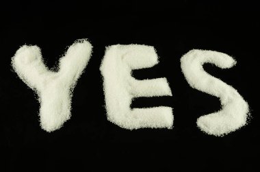 YES from sugar on black background 