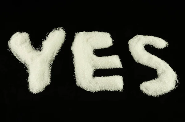 YES from sugar on black background 