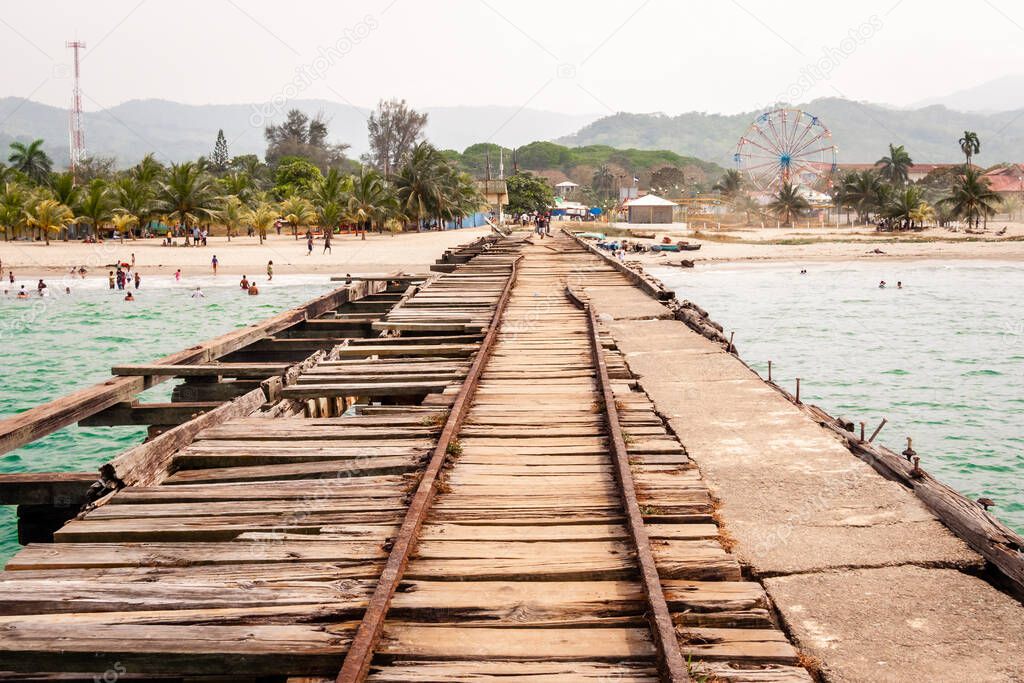Old train track over the sea on the coast of Honduras, former banana transport port