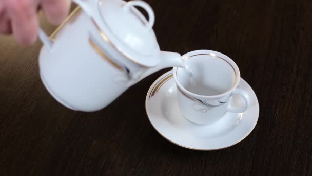 Hot boiled water is poured into a white ceramic cup — Stock Video