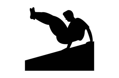 Bir adam bir parkour tarzda bir duvarın üzerinden atlama