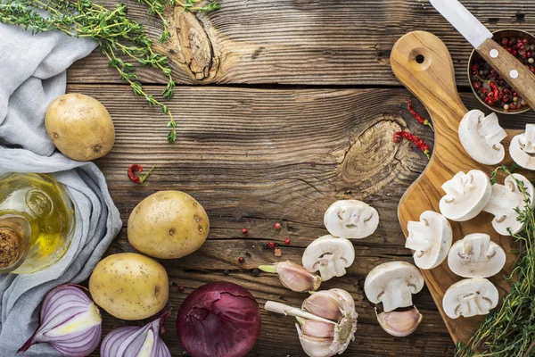 Ingredients for homemade lunch. Mushrooms, potatoes, onions, garlic, olive oil. Top view — Stock Photo, Image