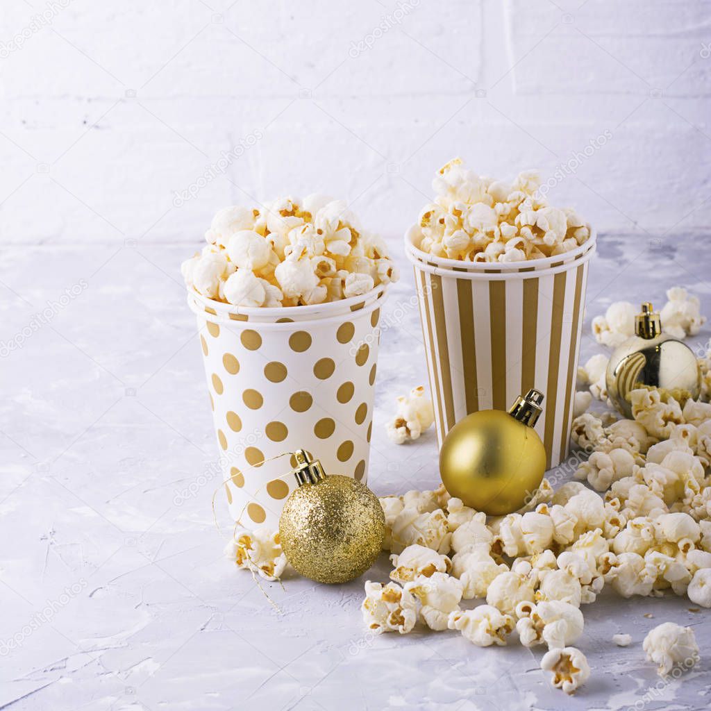Popcorn in paper cup on white background.
