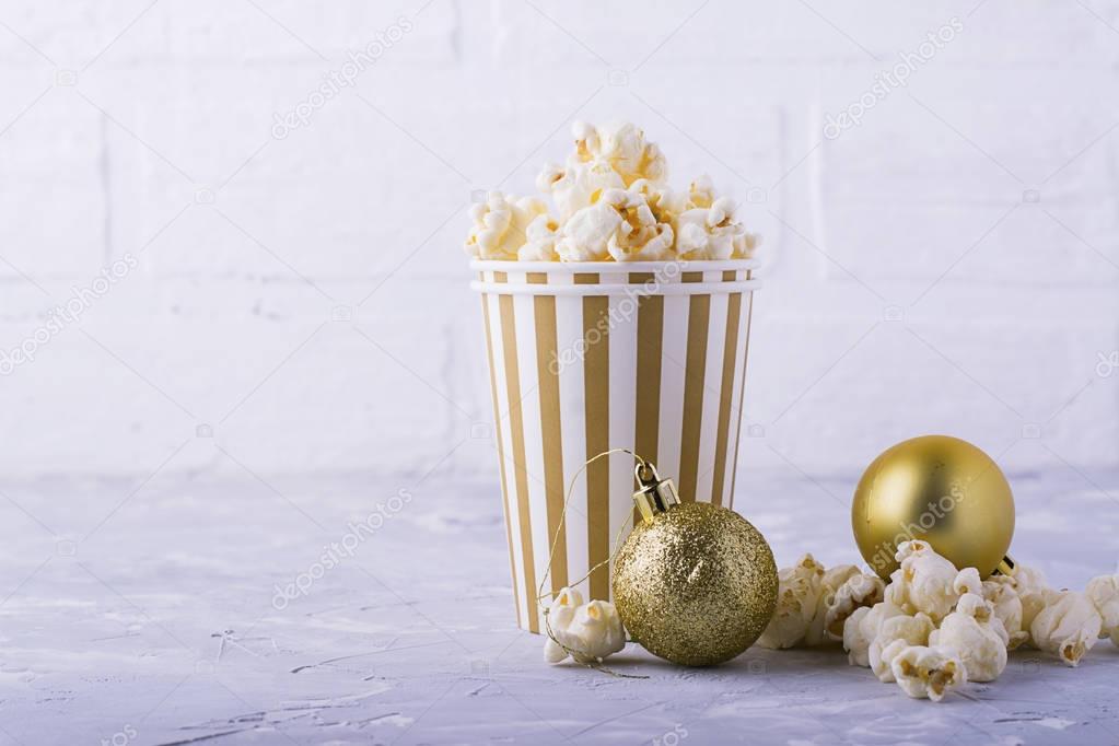 Popcorn in paper cup on white background.