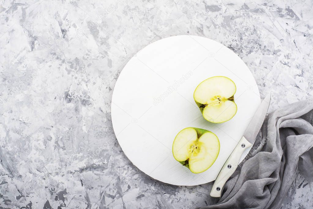 fashionable colors, the green apples on a gray marble table   white cutting board. Top view