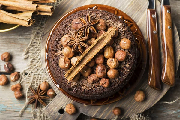 Homemade chocolate crazy cake with chocolate chips, nuts hazelnuts, cinnamon and spices for a cozy autumn tea party. Top View. — Stock Photo, Image