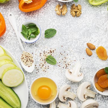 Sağlıklı mevsimlik yeşil, turuncu ve beyaz çiçekleri beslenme için malzemeler: salatalık, kabak, yumurta, mantar, Kuru Kayısı, tatlı biber, portakal, quinoa, badem, ceviz, nane, frisee salata. Hedef