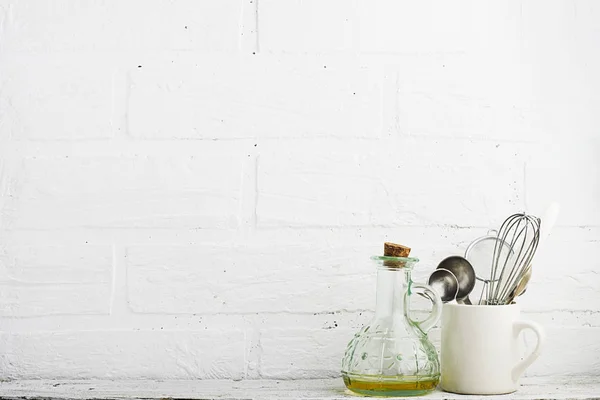 Kitchen tools on a kitchen shelf against a white brick wall. selective focus