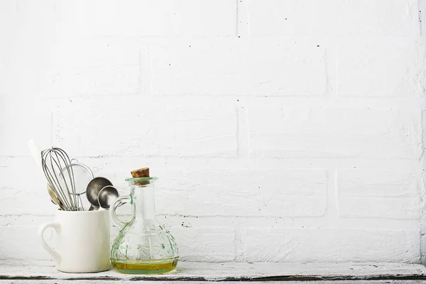 Kitchen tools on a kitchen shelf against a white brick wall. selective focus