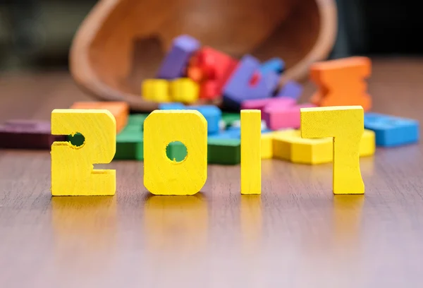 2017 new year number yellow color toy on wood table with other f — Stock Photo, Image