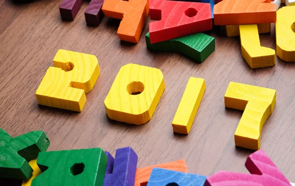 2017 new year number yellow color toy on wood table with other f — Stock Photo, Image