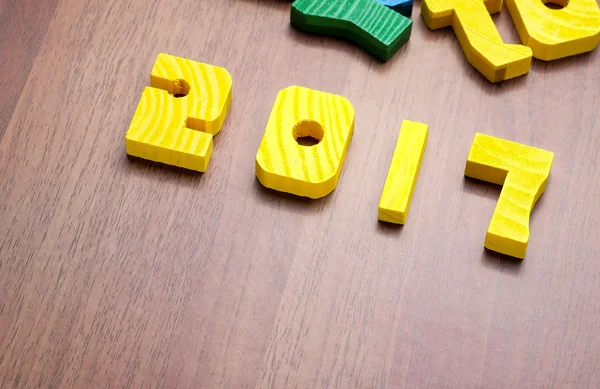 2017 new year number yellow color toy on wood table with other f — Stock Photo, Image