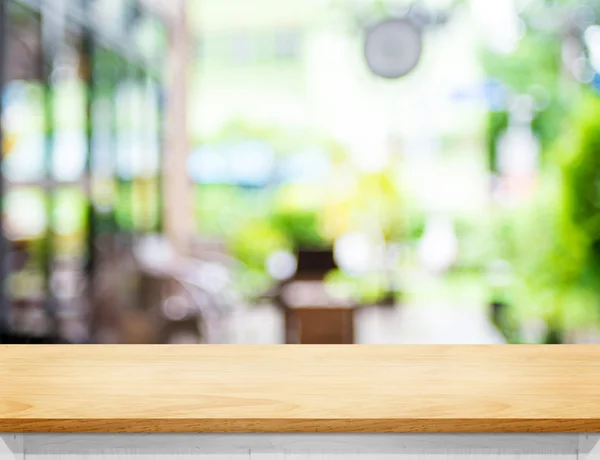 Empty beige color wood table and blurred garden cafe light backg — Stock Photo, Image