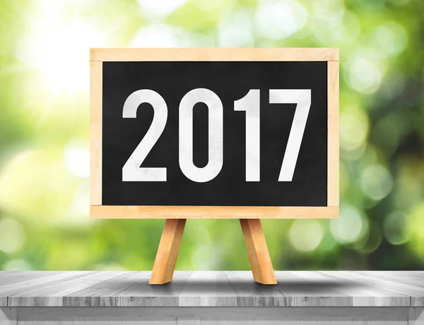 2017 new year on blackboard on plank white wood with green abstr — Stock Photo, Image
