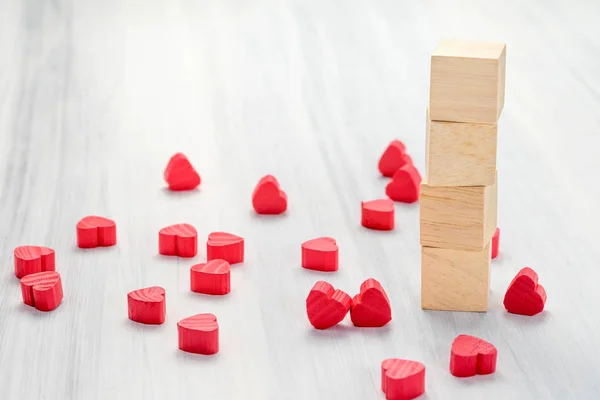 Stack of blank wood cube with group of mini red heart on white r — Stock Photo, Image