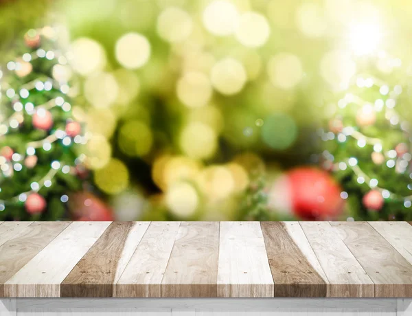 Pale Wood table top with abstract blur christmas tree background — Stock Photo, Image