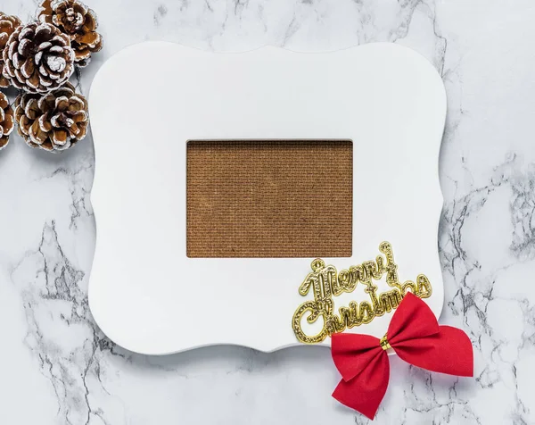 Merry christmas text on vintage white picture frame with pine co — Stock Photo, Image