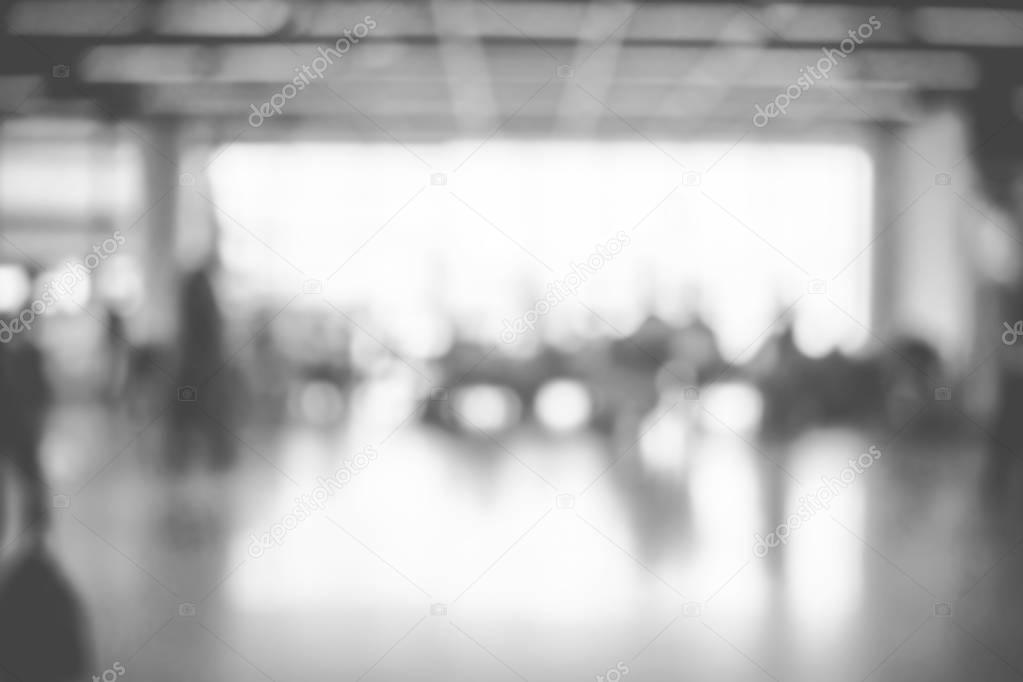 Blur background,black and white color of poepple walking at corr