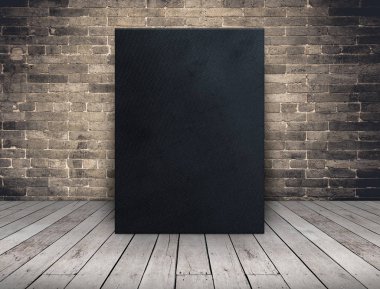 Blank black fabric canvas frame at grunge brick wall and wood pl clipart