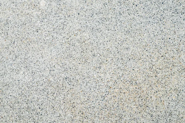 Закрыть небольшой каменный камешек на фоне бетонного пола текстуры — стоковое фото
