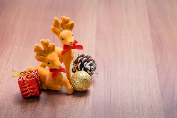 New year and Christmas decoration reindeer and gift on brown woo