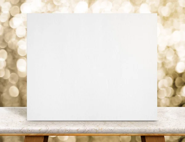 Blank white paper poster on marble table top and sparkling gold