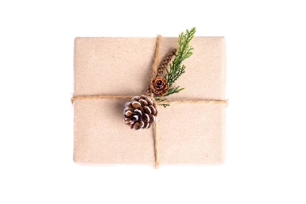 Brown paper craft warped on present box decorate with pine cone — Stock Photo, Image
