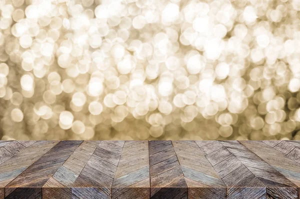 Empty wood table top with blur sparkling gold bokeh abstract bac — Stock Photo, Image