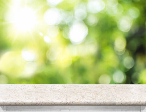 Empty Marble table top with blur green boekh tree background wit