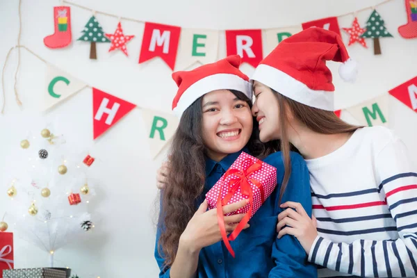Asia lover Girlfriend kiss cheek and give Christmas gift at xmas