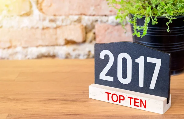 New year 2017 top ten topic number on blackboard sign and green — Stock Photo, Image