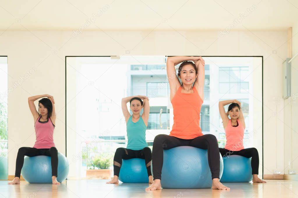 Yoga class in studio room,Group of people doing yoga pose with t