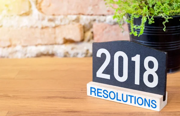 New year 2018 resolutions on blackboard sign and green plant on — Stock Photo, Image