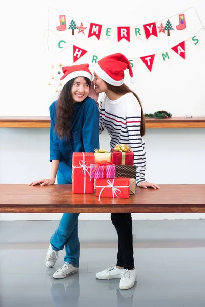 Asia girl friends wear santa hat in Christmas and new year party