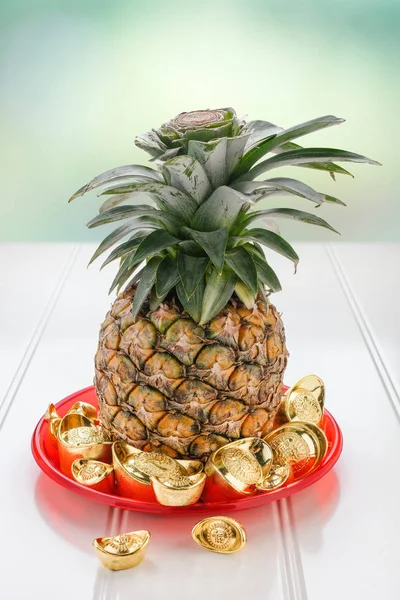 Chinese Chinese New year concept,pineapple with group of gold in — Stock Photo, Image