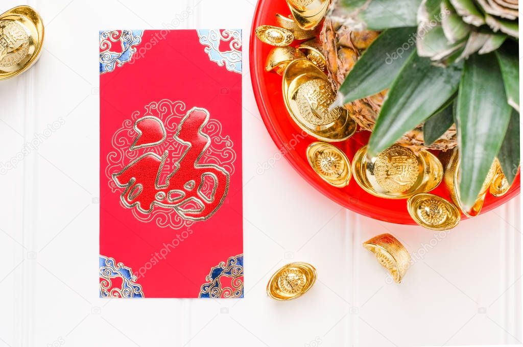 Chinese New year red envelope packet ( ang pow ) and pineapple w