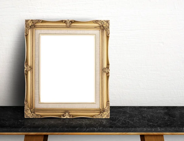 Blank Gold victorian picture frame on black marble table at grey